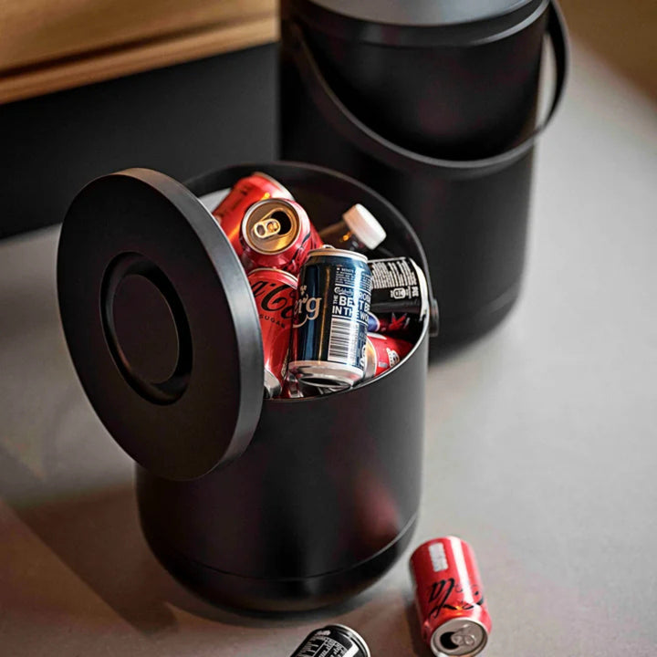 Zone Denmark Circular Abfalleimer in Schwarz mit geöffnetem Deckel und Getränkedosen im Inneren – Anwendung im Haushalt