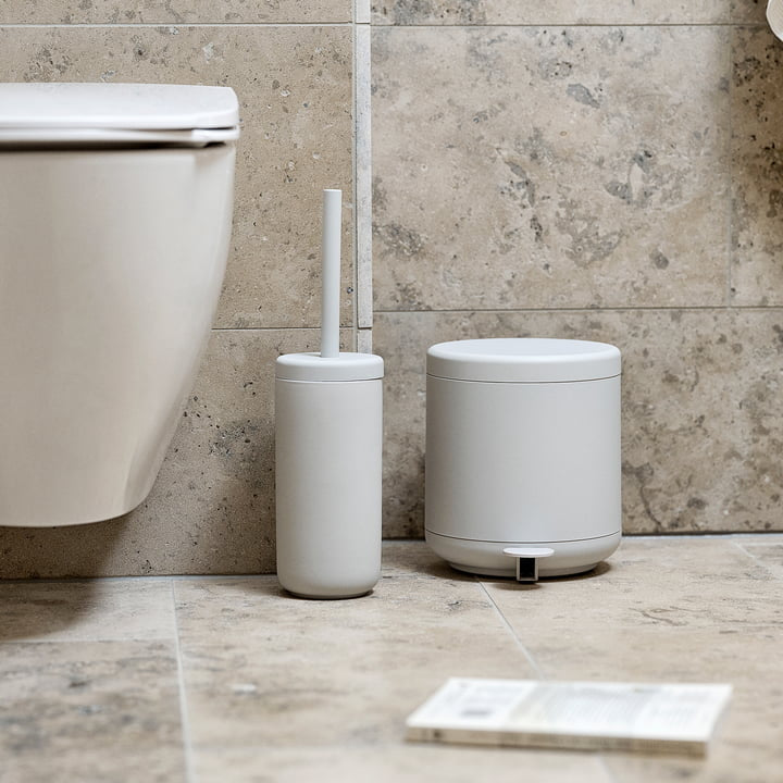Zone Denmark Treteimer Ume und Toilettenbürste Ume in Hellgrau neben dem WC vor Natursteinwand